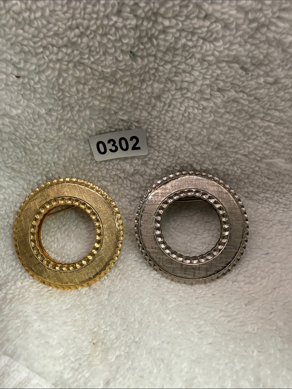 2 Diamond cut scarf clip slide ring brooches. Gold toned and silver toned